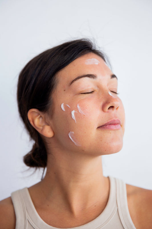 Native woman with skincare cream in her face 