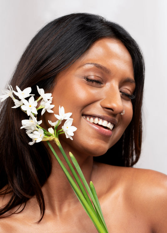 Asian woman holding daffodils 